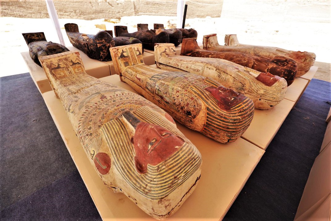 Numerous sarcophagi laid out on a table
